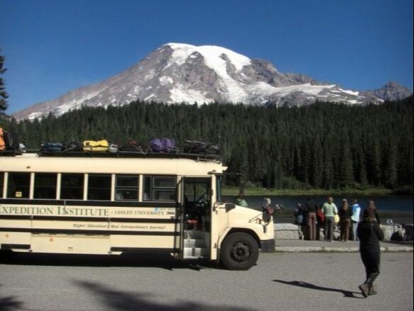 Photo of the Audubon Expedition Institute bus parked at Mount Rainer NP and students looking at the resource in the background